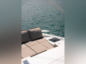 A cozy lounge area on a boat featuring plush cushions, perfect for relaxing while enjoying the serene waters.