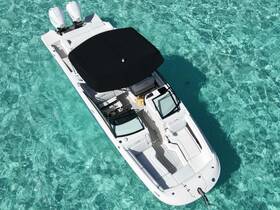 A stunning aerial view of a sleek speedboat gliding through crystal-clear waters, perfect for adventurous outings or leisurely cruises.