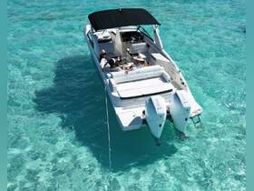 A group enjoys a relaxing day on a boat in crystal-clear turquoise waters, perfect for sunbathing and socializing.