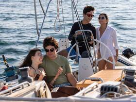A joyful group enjoys a sailing experience on a yacht, capturing moments of laughter and connection on the open water.