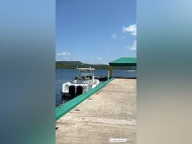 A scenic view of a boat docked at a marina in Culebra, Puerto Rico, showcasing the tranquil waters and surrounding greenery — perfect for exploring the beautiful islands.