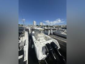 A well-maintained boat docked at a marina, surrounded by other vessels and high-rise buildings, showcasing a vibrant boating scene.