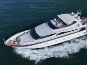 A stunning aerial view of a luxurious yacht cruising through clear waters, showcasing its elegant design and spacious deck.