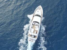 Aerial view of a sleek yacht cruising through deep blue waters, showcasing its elegant design and spacious deck — perfect for luxury charters and ocean adventures.