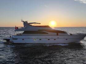 A stunning yacht glides through the water at sunset, showcasing its elegant design against a vibrant sky — perfect for luxury cruising experiences.
