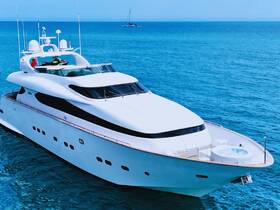 A stunning aerial view of a luxurious yacht cruising through clear blue waters, showcasing its elegant design and amenities.