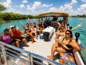 A lively group enjoys a fun day on a boat, celebrating with friends in a beautiful waterway — perfect for memorable outings and parties.