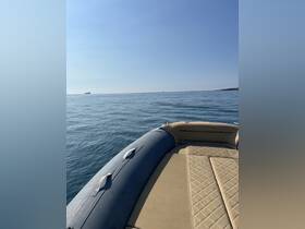 A serene view of the side of a boat cruising on calm waters, showcasing the sleek design and tranquil surroundings.