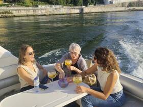A lively group enjoys cocktails on a boat, creating a perfect atmosphere for celebration and relaxation on the water.