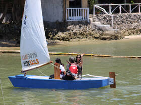 A group enjoys a sailing adventure on a small boat, capturing the joy of water activities and camaraderie under the sun.