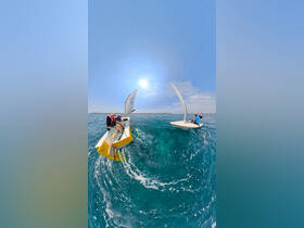 A lively group enjoys sailing on clear turquoise waters, showcasing the thrill of on-water activities under the sun.