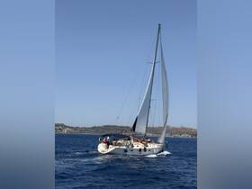 A lively group enjoys a sailing adventure aboard a yacht, showcasing the thrill of on-water activities against a stunning coastal backdrop.