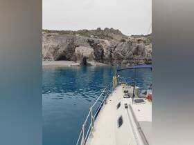 A picturesque view of a boat approaching stunning rock formations along a serene coastline, showcasing the beauty of nature and the adventure of boating.