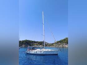 A sailboat glides through clear blue waters with guests enjoying the sun and scenery — perfect for a day of relaxation and adventure on the water.