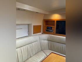 Interior view of a cozy boat cabin featuring comfortable seating and a console, perfect for relaxing during a day on the water.