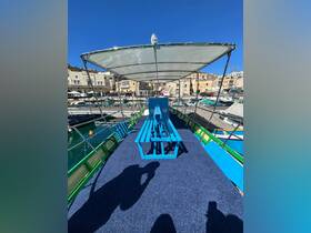 Interior view of a boat featuring blue seating and a spacious deck area, perfect for relaxing while enjoying the marina scenery.