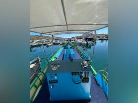 A view of the helm area inside a colorful boat, showcasing the control panel and seating, ideal for navigating the waters.