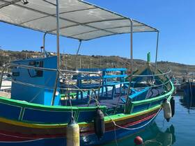 A vibrant fishing boat docked at the marina, showcasing its colorful design and structure against a clear blue sky.