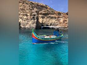 A vibrant boat navigates through crystal-clear waters, framed by stunning rocky cliffs — an ideal setting for exploring coastal landscapes.
