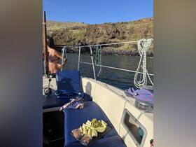 A selection of fresh fruits and cookies laid out on a boat's seating area, perfect for enjoying snacks while cruising the scenic waters.