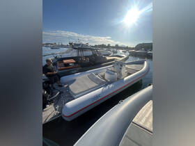 A sleek speedboat docked at the marina, showcasing its design and structure under the bright sun.