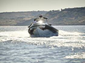A sleek speedboat cuts through the water, showcasing its dynamic design and performance. Ideal for thrilling adventures on the open sea.