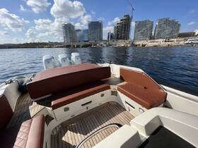 A stylish interior view of a boat showcasing comfortable seating and a well-designed helm area, perfect for enjoying a day on the water.