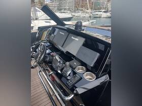 A detailed view of the helm and console area of a luxury boat, showcasing advanced navigation equipment and sleek design, perfect for a modern boating experience.