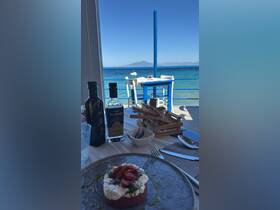 A beautifully presented dish with a stunning seaside view, perfect for enjoying a meal while soaking in the coastal atmosphere.