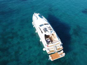 A stunning aerial view of a luxurious yacht cruising over crystal-clear waters, showcasing its elegant design and spacious deck, perfect for a day on the water.