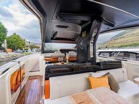 A stylish interior view of a luxury boat's lounge area, featuring comfortable seating and elegant decor, perfect for relaxing on the water.