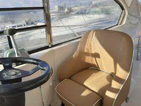 A cozy interior view of a boat's helm and seating area, showcasing the stylish design and comfort for an enjoyable boating experience.