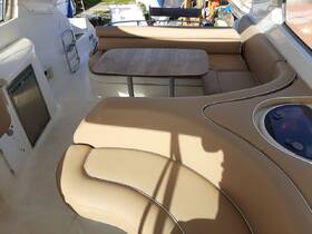 A cozy interior view of a boat's seating area, featuring comfortable cushions and a central table, perfect for relaxing on the water.