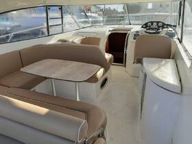 Interior view of a boat cabin featuring comfortable seating and a helm, ideal for relaxing and navigating on the water.