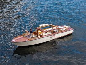 A stylish speedboat named 'AC BOAT' glides through the shimmering waters, showcasing its elegant design and perfect for leisurely outings.