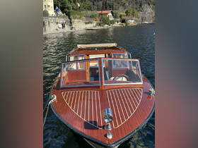 A stunning view of a classic wooden yacht docked on serene waters, showcasing its elegant design and craftsmanship.