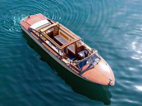 A stylish boat glides through calm waters with a captain at the helm, showcasing a perfect day on the water.