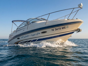 A sleek speedboat cuts through the waves, showcasing its design and performance on the open water.