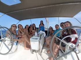 A joyful group of friends enjoys a sailing adventure, capturing fun moments aboard the boat — perfect for celebrations and memorable outings on the water.