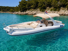 A sleek speedboat glides through crystal-clear waters, showcasing its elegant design and inviting seating — perfect for a day of adventure on the sea.