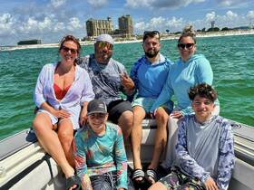 A cheerful group enjoys a sunny day on the boat, capturing fun moments together — perfect for family outings or group adventures on the water.