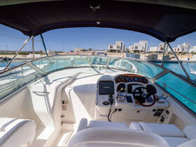 The interior view of a boat's helm showcases a well-equipped console and comfortable seating, perfect for navigating the waters in style.
