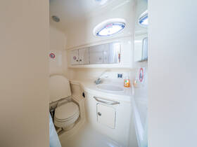 A clean and well-equipped bathroom inside a boat, featuring a toilet and sink, ideal for comfort during voyages.