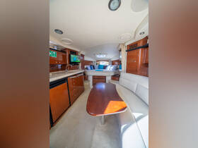Interior view of a yacht's cabin featuring comfortable seating and modern amenities, perfect for relaxing during your boating adventures.