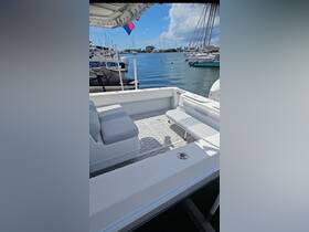 Interior view of a spacious boat seating area, showcasing comfortable seating and a clean layout, perfect for relaxing on the water.