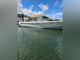 A sleek center console boat named 'Melicious' docked in calm waters, showcasing its modern design against a picturesque backdrop.