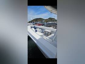 Interior view of a boat showcasing seating and a cooler, perfect for relaxing and enjoying refreshments while on the water.
