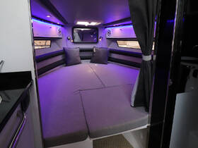 A modern boat cabin featuring comfortable seating and ambient lighting, perfect for relaxing during your nautical adventures.