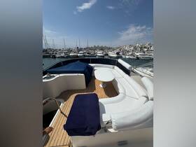 A stylish interior view of a yacht's lounge area, featuring comfortable seating and a beautiful marina backdrop, perfect for relaxing on the water.