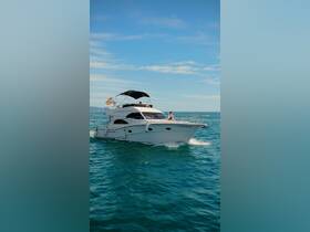 A sleek yacht cruising through clear waters, showcasing its elegant design and perfect for luxury outings on the sea.